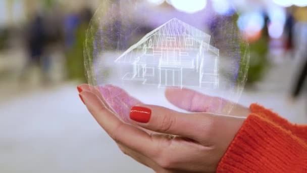 Female hands holding a conceptual hologram with house — Stock Video