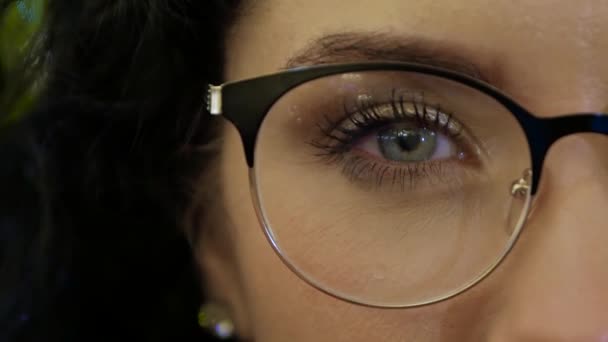 Attractive woman touches the rim of glasses — Stock Video