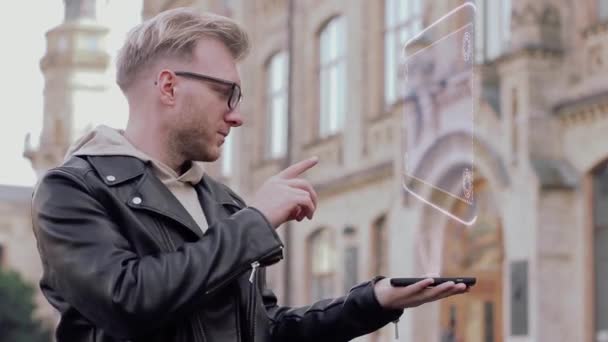 Man with glasses shows a conceptual hologram astronaut — Stock Video