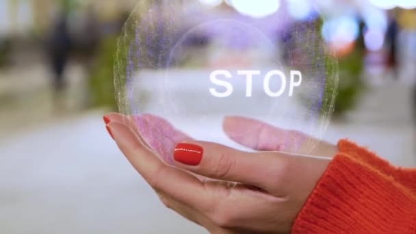 Female hands holding hologram with text Stop — Stock Video