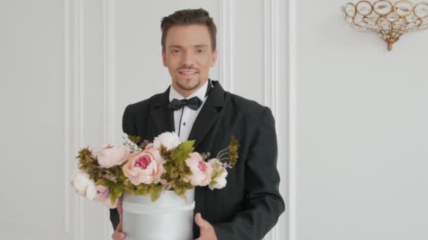 Stylish guy holds out a bouquet — Stock Video