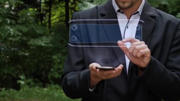 Empresario utiliza holograma con texto criptomoneda — Vídeo de stock