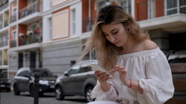 Dziewczyna używać biały smartfon odkryty — Wideo stockowe
