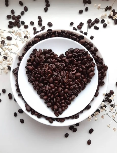 Coffee beans on a saucer in the form of a heart. Coffee Bean Heart