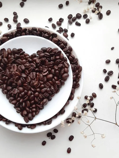 Coffee beans on a saucer in the form of a heart. Coffee Bean Heart