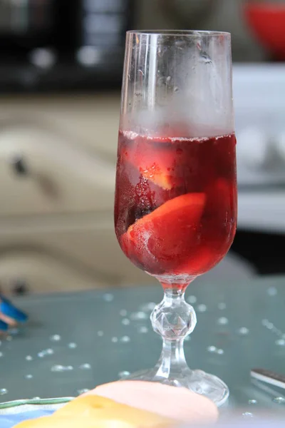 Glass with red sangria on the table