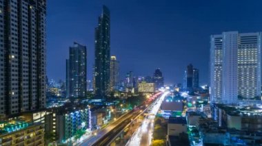 Cityscape aerial view timelapse at night bangkok, Busy traffic across main road at rush hour thailand.