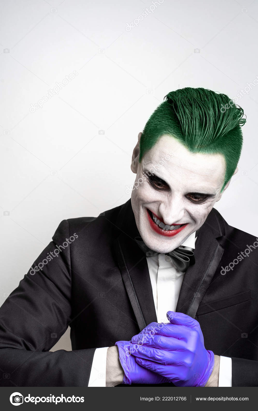 Portrait Of A Joker Makeup For Halloween Crazy Image Of A Man In A Black Suit And A White Shirt With A Butterfly Green Hair Stock Photo By C Shulgenko007