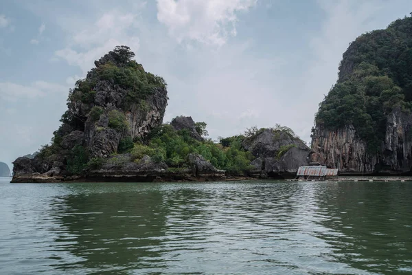 Vacation in sunny Asia. Excursion between the islands of Pang Nga Bay. Activities and adventures. Fancy rocks in the water