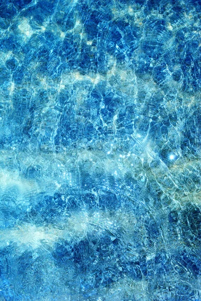 Summer minimalist background, sea with crystalline, blue and sparkling waters, from above, vertical