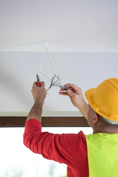 Hands of an electrician, electrician at work, handyman and electrical installation — Stock Photo, Image