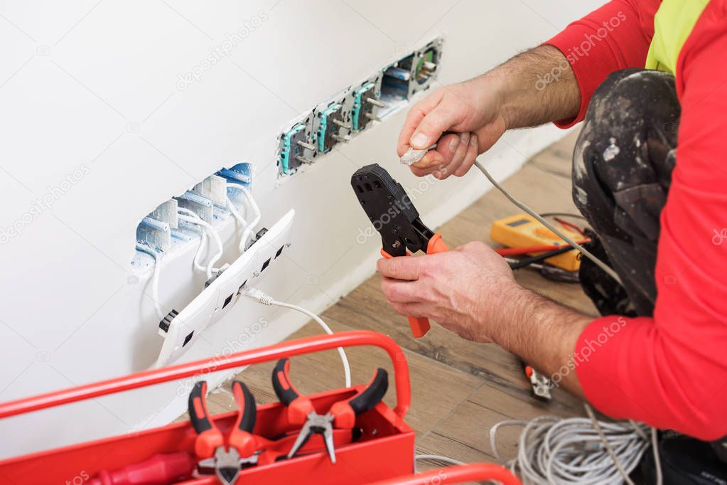electrician at work, home renovation, electrical installation, Hand of an electrician, handyman at work