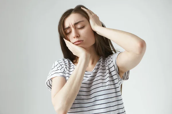 Stressed young woman suffering having bad toothache and headache.