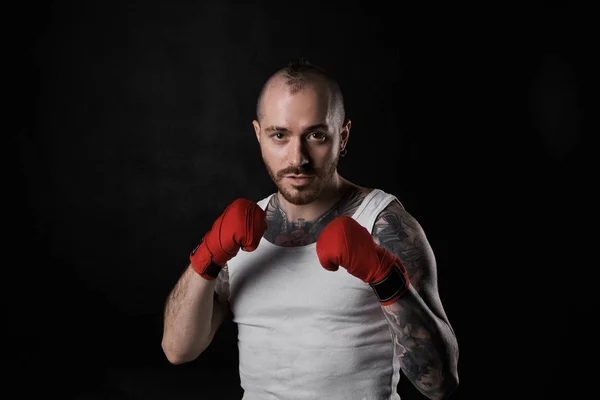 Martial arts, sports, kickboxing, fitness and bodybuilding. Waist up portrait of handsome athletic muscular kickboxer dressed in white t-shirt, holding fists in front of him, showing his readiness