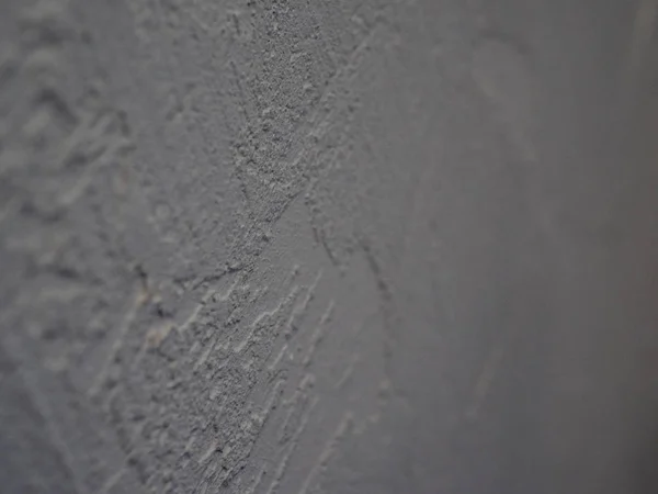 White abstract background or texture of concrete wall with rough stucco. Textured damaged plaster, loft style.