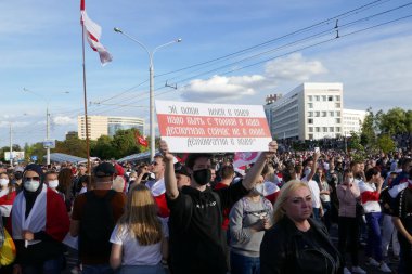 Minsk 'te polis hukuksuzluğuna ve Beyaz Rusya' daki cumhurbaşkanlığı seçimlerinin sahteciliğine karşı düzenlenen bir protestoda bayrakları, pankartları ve pankartları olan insanlar.