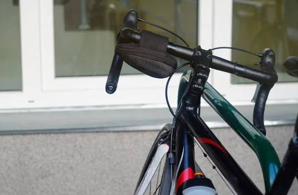 road bike with front brakes and a bag cover on the front handlebars, theme objects