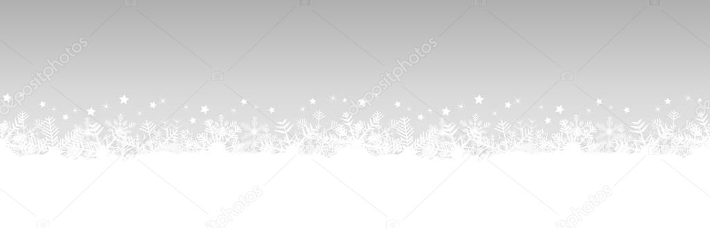 white snow flakes on bottom side and silver colored christmas background