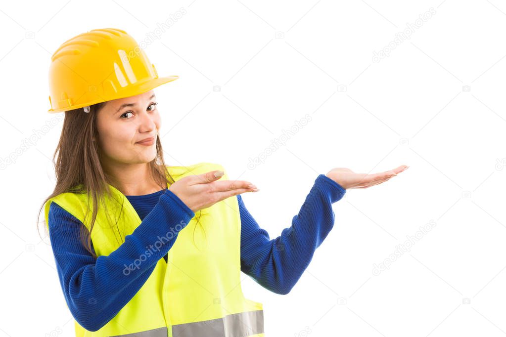 Young beautiful female architect or engineer making presentation gesture with hands as showing advertising concept isolated on white background