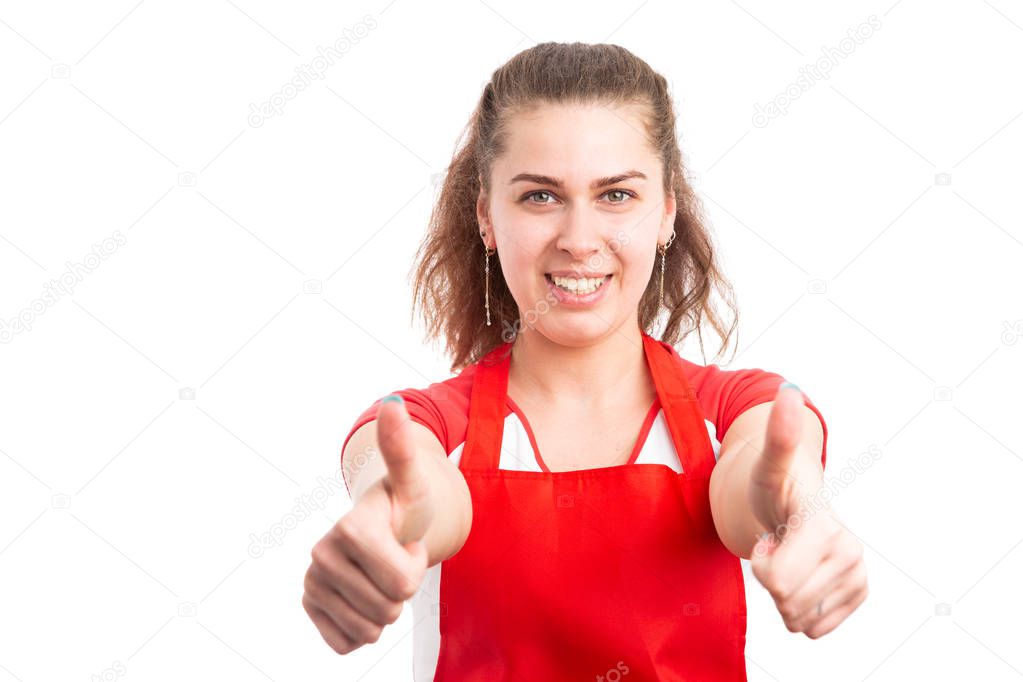 Young woman supermarket employee showing thumbs up like gesture as happy retailer concept isolated on white background