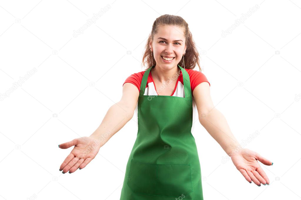 Young woman retail or supermarket worker making welcome gesture with hands as employee hospitality concept isolated on white background