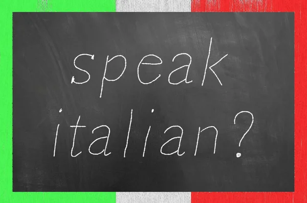 Speak Italian chalk text on flag frame blackboard or chalkboard as foreign language school university lesson concept