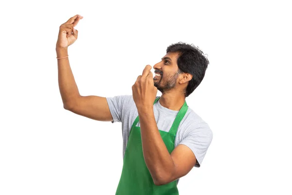 Friendly hypermarket or supermarket employee holding up crossed fingers with both hands as success and good luck concept isolated on white studio background