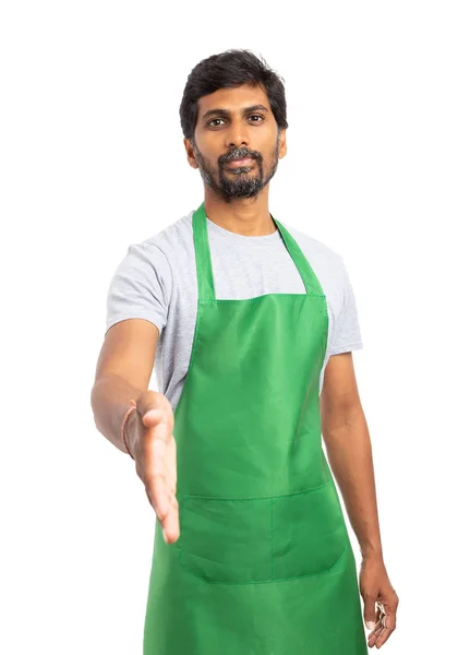 Indian shop manager or supermarket employee offering handshake as partnership concept isolated on white studio background