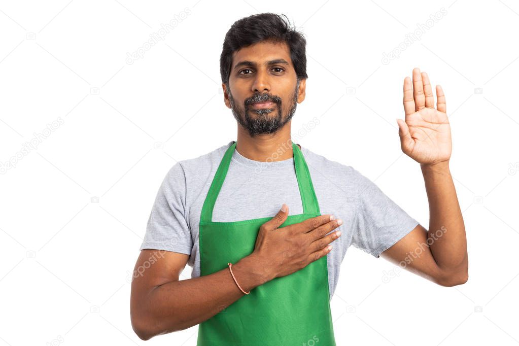 Hypermarket or supermarket man employee holding hand on heart and up as oath gesture expressing honesty and loyalty isolated on white background