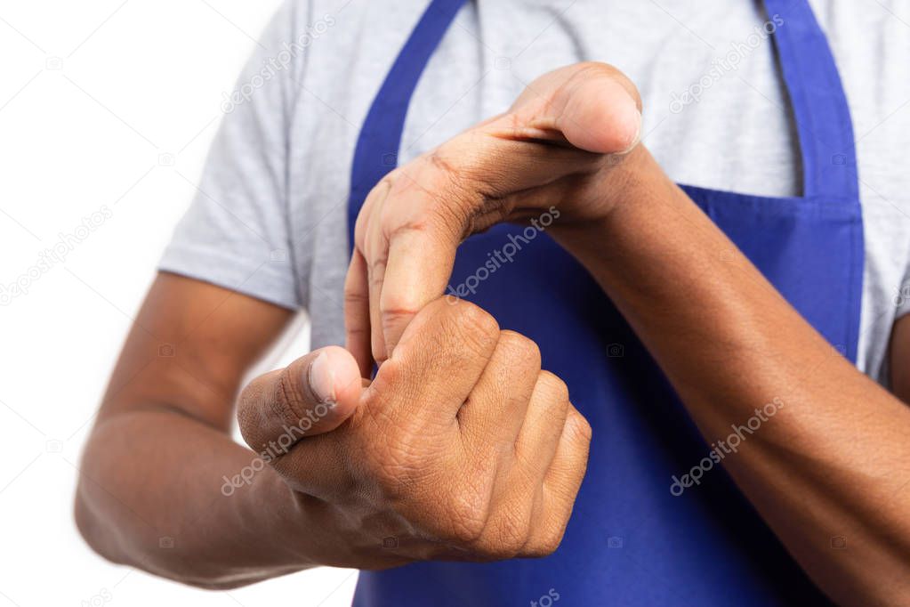 Close-up of knuckles being cacked by hypermarket or supermarket indian male employee isolated on white background