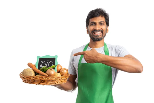Indian Male Grocer Smiling Presenting Vegetable Basket Bio Sign Using — Stock Photo, Image