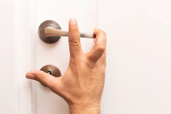 Person Fingers Reaching Metallic Handle White Wooden Door — Stock Photo, Image
