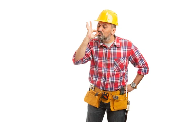 Man builder kissing tip of fingers as good job perfect concept isolated on white studio background