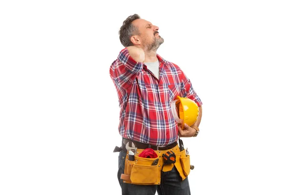 Builder touching painful back of neck with hand as stretching from physical effort isolated on white background