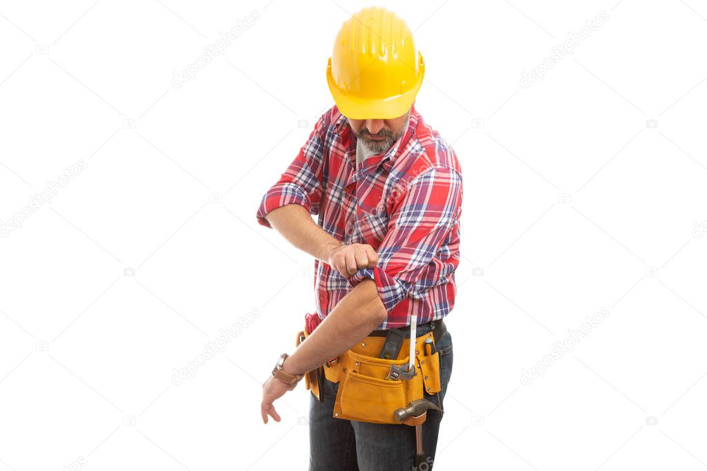 Constructor looking as rolling up plaid shirt sleeve preparing for work isolated on white background