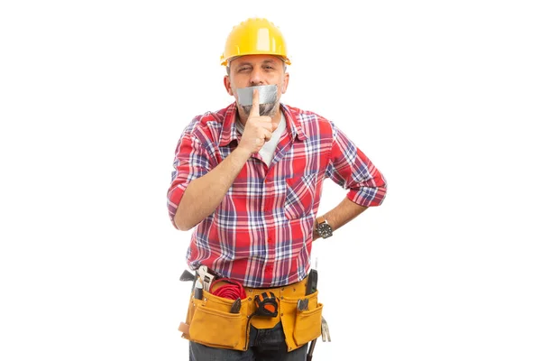 Builder making shush gesture with index finger over duct-taped mouth isolated on white background