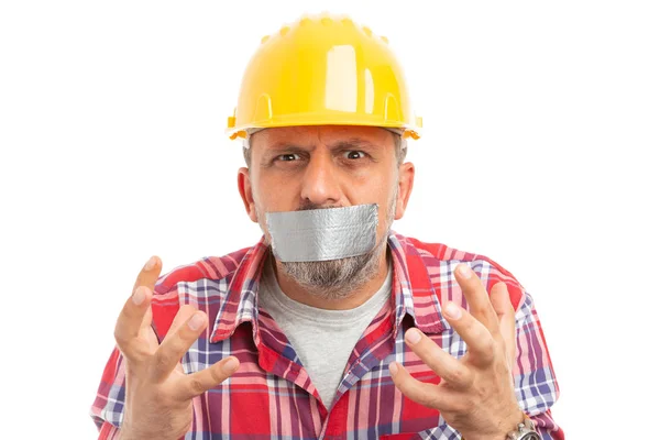 Builder with mouth shut by using grey duct tape making desperate gesture with hands close-up isolated on white background