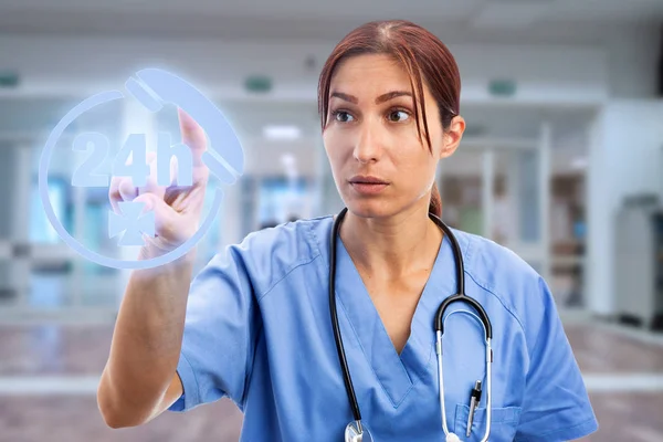 Female nurse touching phone symbol on invisible display as all-day call centre services futuristic concept on hospital room as background