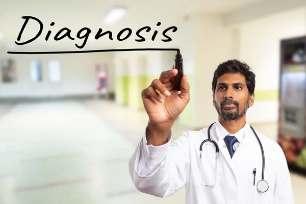 Indian physician or doctor man underlining with black marker diagnosis word on transparent display
