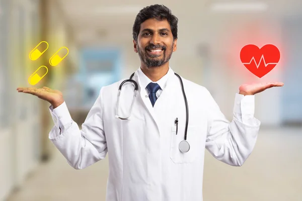 Indian medic man balancing in palm red heart and yellow pill drawings on palm as cardiology medicine concept