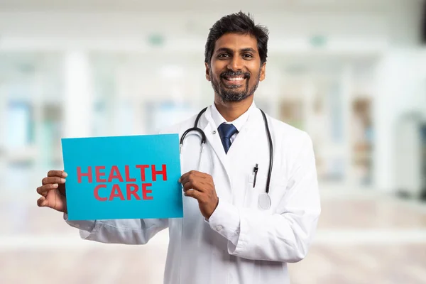 Medic showing health care paper sig — Stock Photo, Image