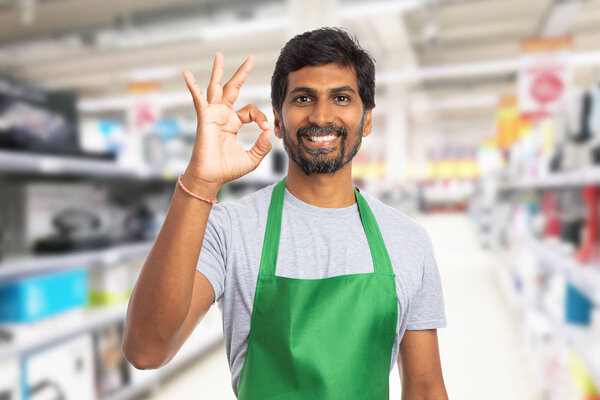 Person working at hypermarket showing okay gestur