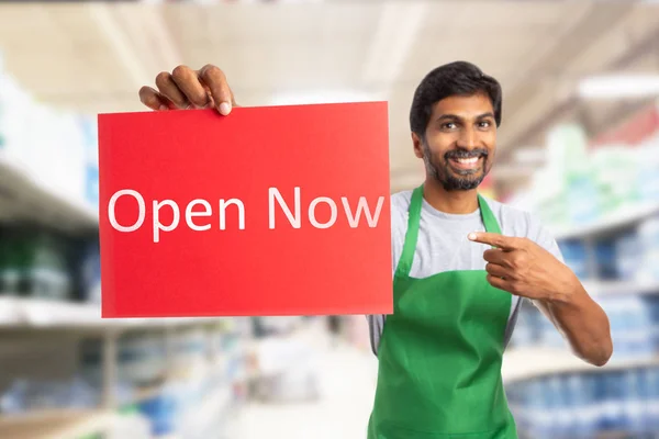 Store owner presenting open now sig — Stock Photo, Image