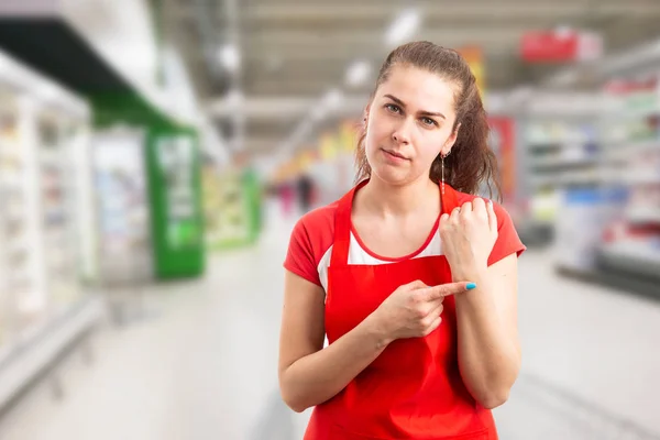 Store owner pointing at wrist as late concep — Stock Photo, Image