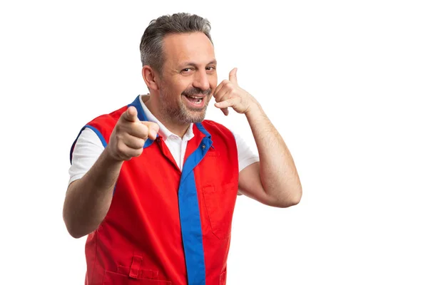 Supermarket employee making call us gesture and pointing at came