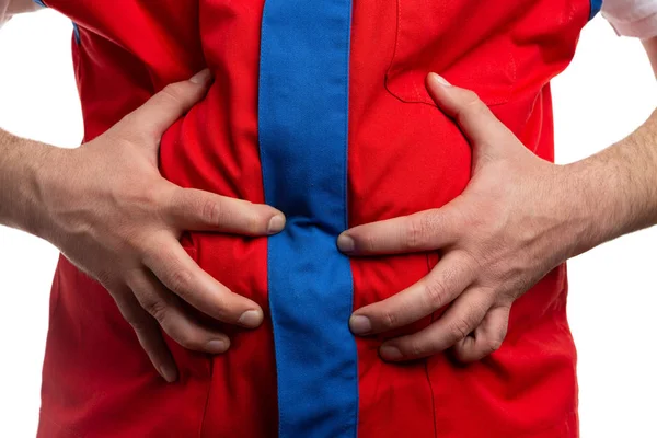 Gros plan de l'employé d'hypermarché touchant stomac — Photo