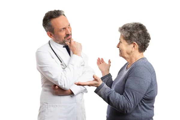 Paziente che fa domande e medico pensando alla risposta — Foto Stock
