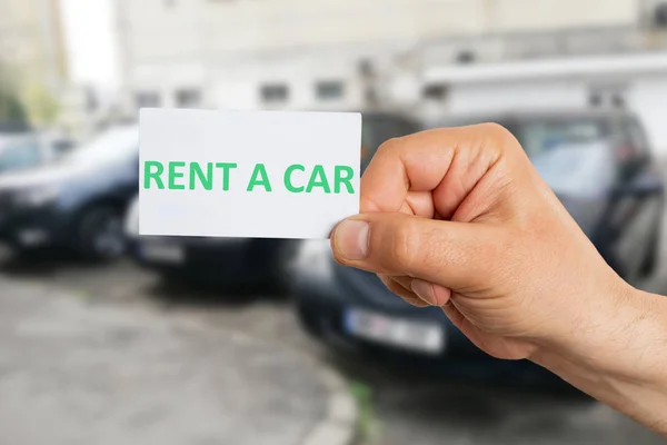 Man presenting card with rent a car text