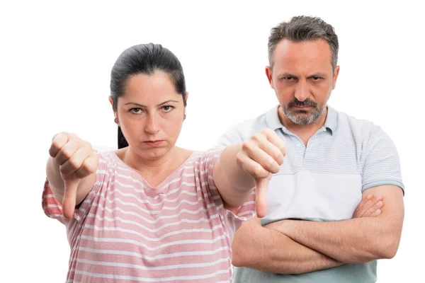 Woman making dislike gesture and man with crossed arms — ストック写真