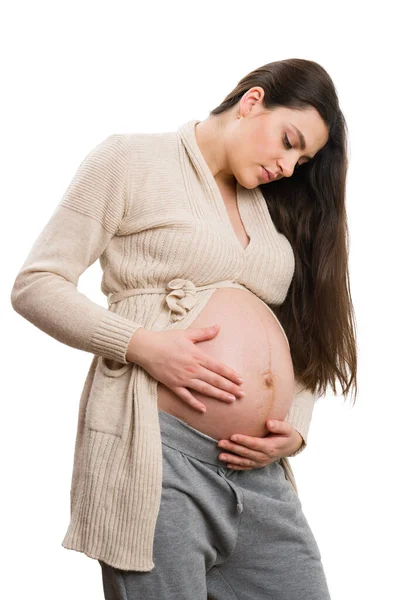 Όμορφη Νεαρή Έγκυος Γυναίκα Ελέγχει Μεγάλη Κοιλιά Της Απομονώνονται Λευκό — Φωτογραφία Αρχείου